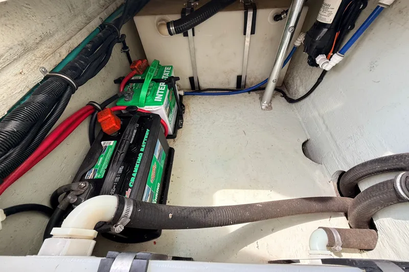 Slide: The Image of Battery compartment of a 1999 Pursuit 2860 Denali boat, featuring Interstate batteries. - 19