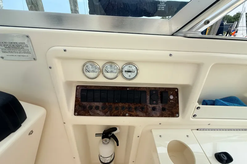 Slide: The Image of 1999 Pursuit 2860 Denali dashboard with gauges, switches, and fire extinguisher. - 10
