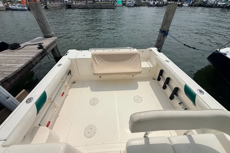 Slide: The Image of 1999 Pursuit 2860 Denali boat interior with seating, docked at marina. - 7