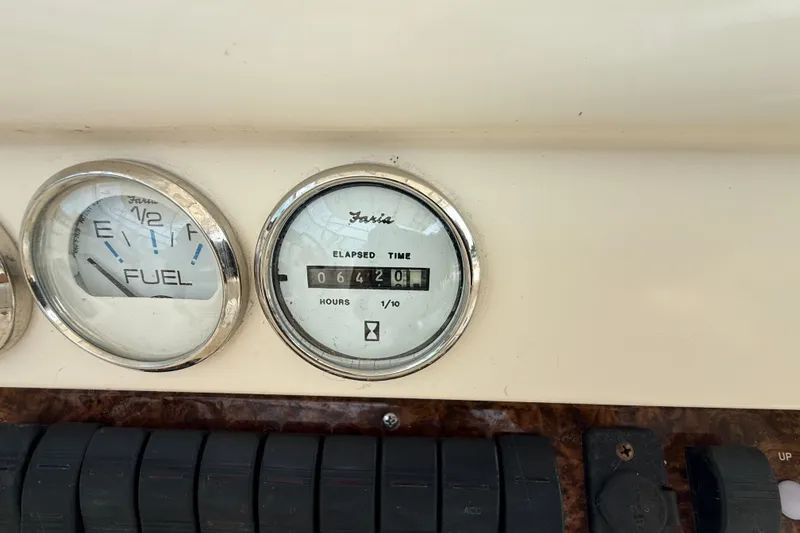 Slide: The Image of 1999 Pursuit 2860 Denali dashboard with fuel and elapsed time gauges. - 11