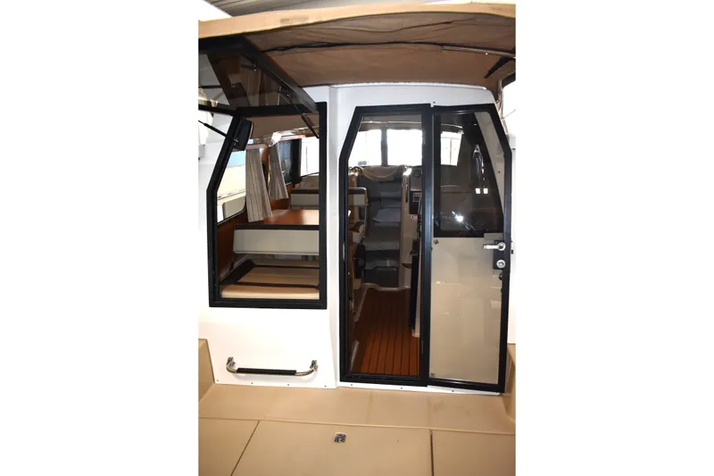 Slide: The Image of 2019 Ranger Tugs R-23 boat interior with seating and helm, featuring modern design elements. - 22
