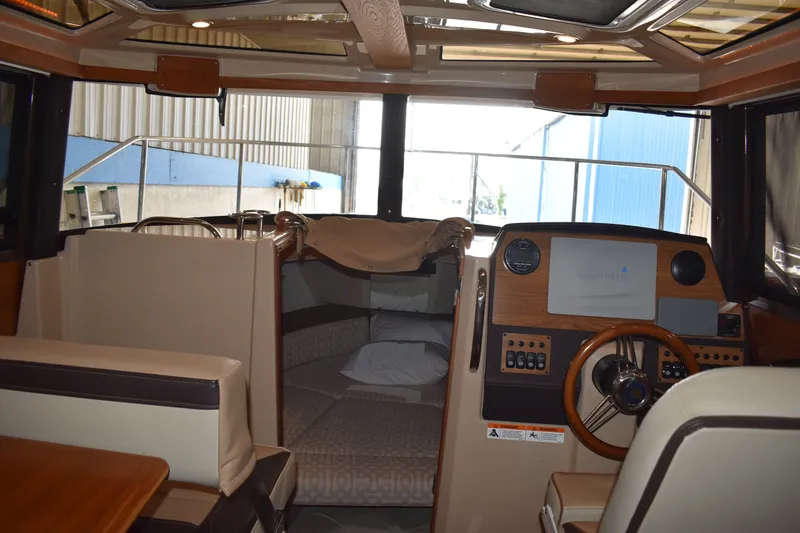 Slide: The Image of Interior of 2019 Ranger Tugs R-23 boat with helm and seating area. - 34