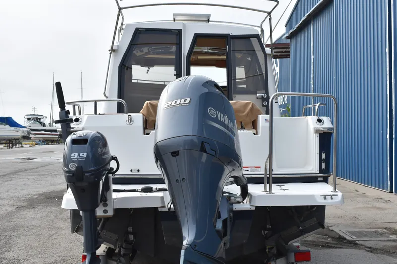 Slide: The Image of 2019 Ranger Tugs R-23 boat with Yamaha outboard motors at a marina. - 8