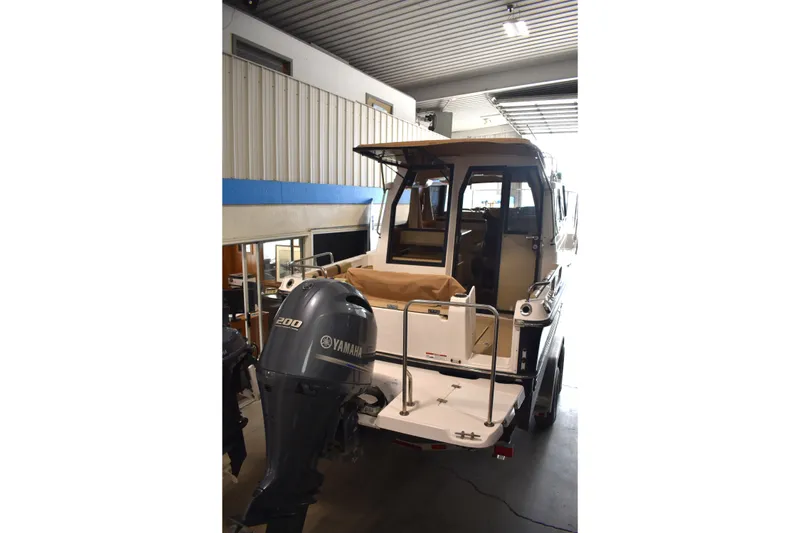 Slide: The Image of 2019 Ranger Tugs R-23 boat with Yamaha 200 engine in a garage. - 14