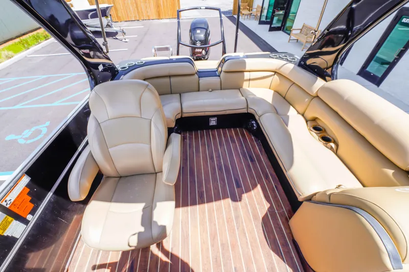 Slide: The Image of 2016 South Bay 724 SPORT DLX boat interior with tan seating and wood flooring. - 23
