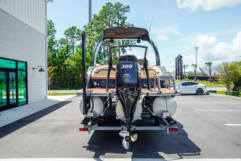 Slide: The Image of 2016 South Bay 724 SPORT DLX pontoon boat on trailer in parking lot. - 4