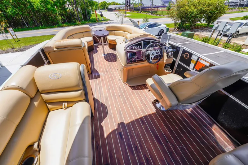 Slide: The Image of Luxurious 2016 South Bay 724 SPORT DLX pontoon boat interior with plush seating and modern dashboard. - 22