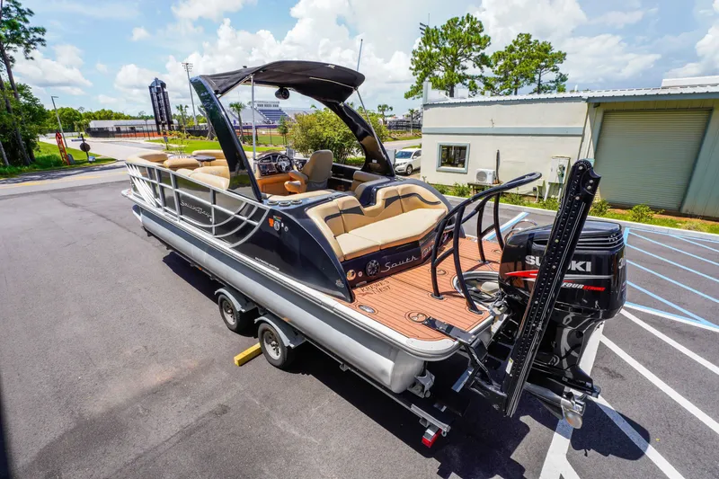 Slide: The Image of 2016 South Bay 724 SPORT DLX pontoon boat with Suzuki outboard motor on trailer. - 14