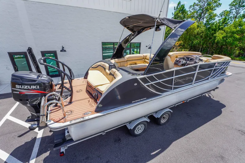 Slide: The Image of 2016 South Bay 724 SPORT DLX pontoon boat with Suzuki engine on trailer. - 13