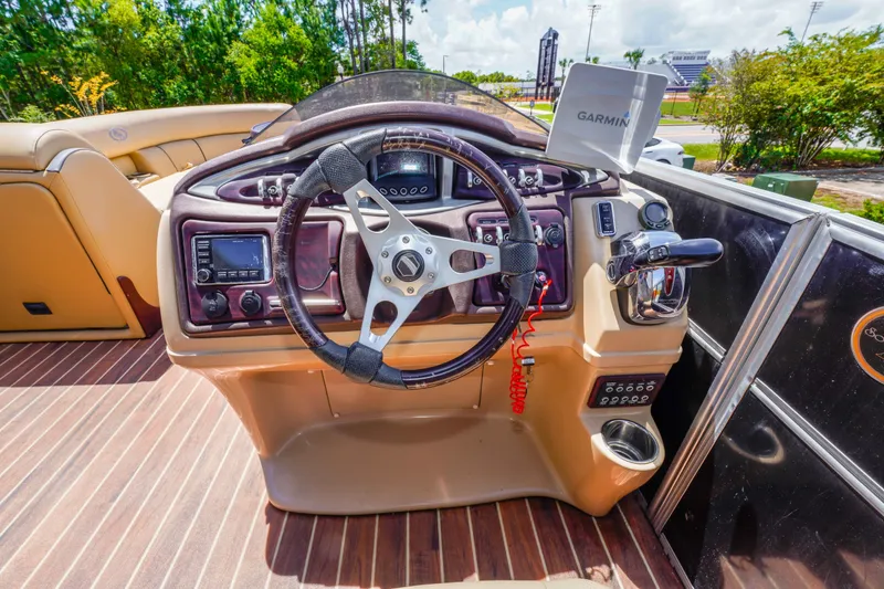 Slide: The Image of 2016 South Bay 724 SPORT DLX boat dashboard with steering wheel and Garmin GPS. - 30