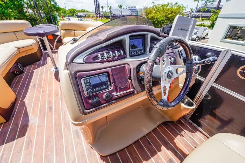 Slide: The Image of Interior view of 2016 South Bay 724 SPORT DLX boat dashboard with steering wheel and controls. - 31