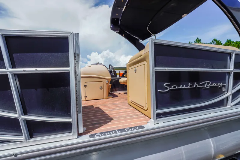 Slide: The Image of 2016 South Bay 724 SPORT DLX pontoon boat with open gate and luxurious interior. - 36