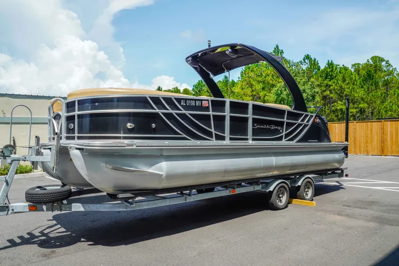 Slide: The Image of 2016 South Bay 724 SPORT DLX pontoon boat on trailer, parked outdoors. - 6
