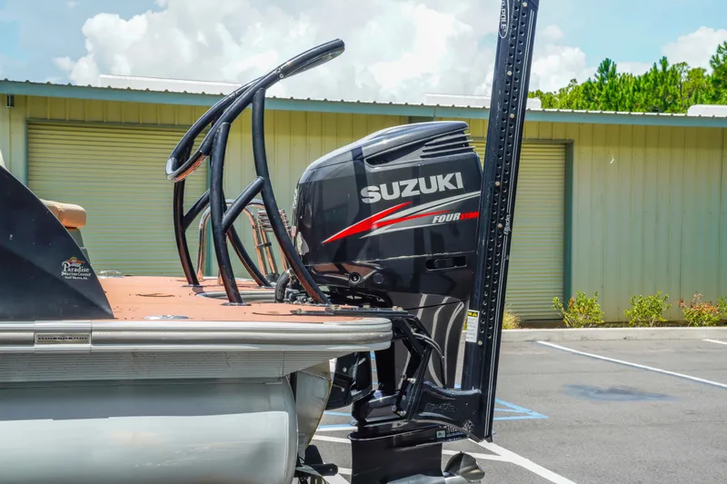 Slide: The Image of 2016 South Bay 724 SPORT DLX with Suzuki outboard motor in a parking lot. - 8
