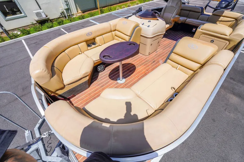 Slide: The Image of 2016 South Bay 724 SPORT DLX pontoon boat with tan seating and wood-style flooring. - 18