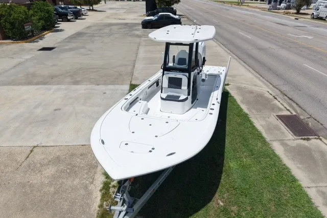 Slide: The Image of 2027 Tidewater 2500 Carolina Bay boat on trailer, parked near a road. - 4