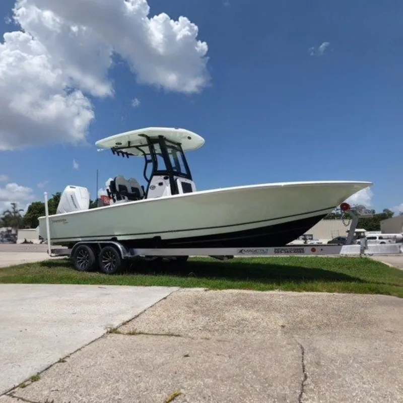 The Image of 2027 Tidewater 2500 Carolina Bay boat on trailer under blue sky. - 0