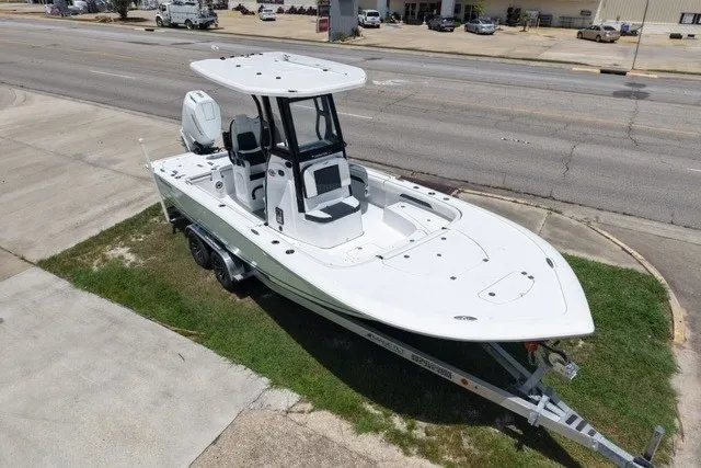 Slide: The Image of 2027 Tidewater 2500 Carolina Bay boat on trailer, parked near a road. - 5