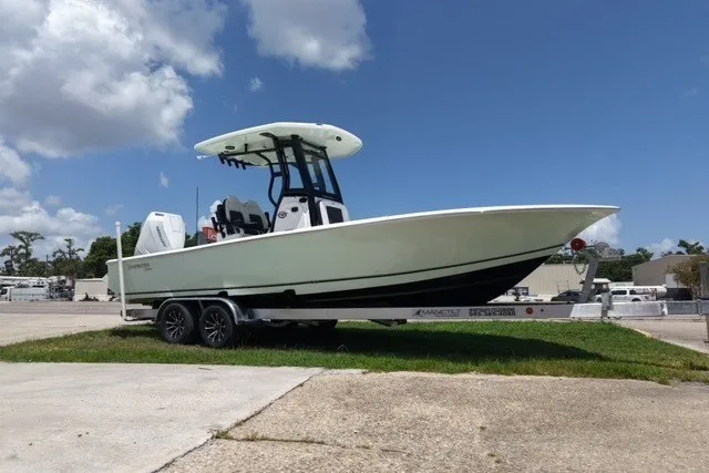 The Image of 2027 Tidewater 2500 Carolina Bay boat on trailer under blue sky. - 0