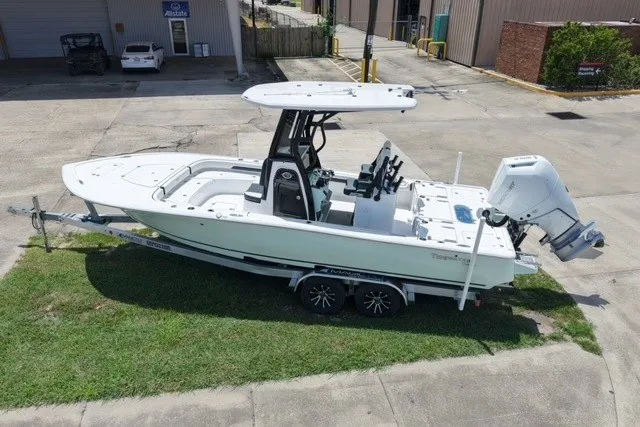 Slide: The Image of 2027 Tidewater 2500 Carolina Bay boat on trailer, parked outdoors. - 2