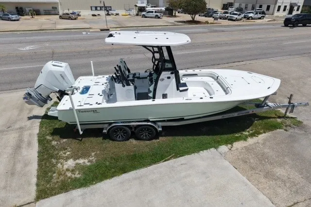 Slide: The Image of 2027 Tidewater 2500 Carolina Bay boat on trailer, parked near a road. - 6