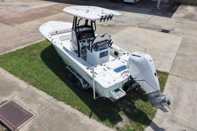 Slide: The Image of 2027 Tidewater 2500 Carolina Bay boat with outboard motor on a trailer. - 1