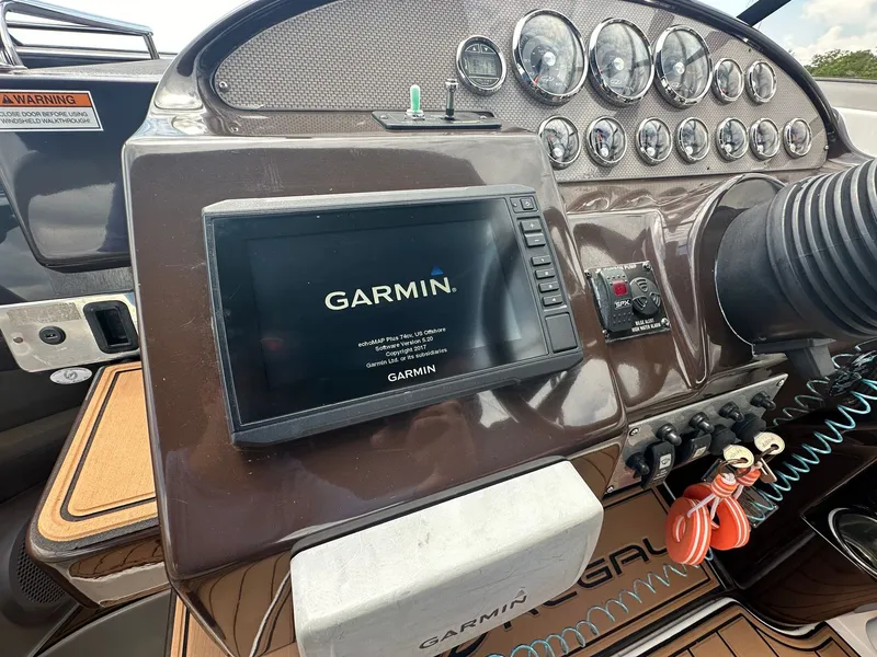 Slide: The Image of The image shows the dashboard of a Regal 30 Express boat with a Garmin navigation system. - 20