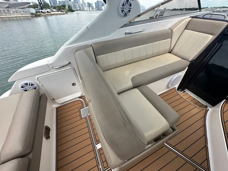 Slide: The Image of Interior of a 2014 Regal 30 Express with beige upholstery and wood flooring. - 13