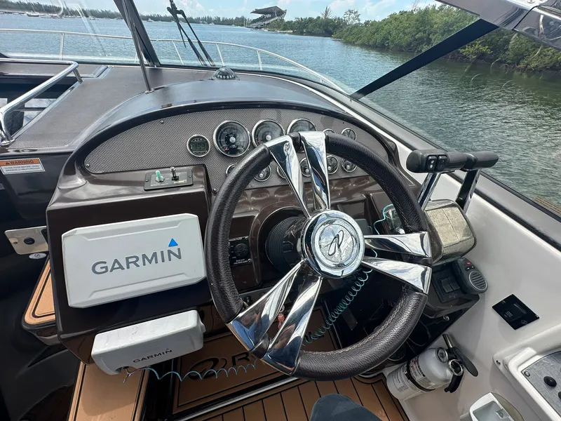 Slide: The Image of The image shows the helm of a 2014 Regal 30 Express boat with Garmin navigation. - 19