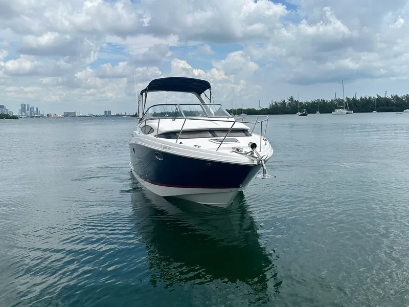 Slide: The Image of A 2014 Regal 30 Express boat on calm water with a cloudy sky in the background. - 3
