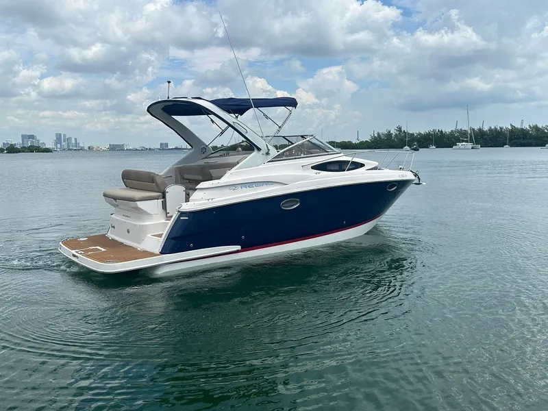 Slide: The Image of A 2014 Regal 30 Express boat on calm water with a cloudy sky. - 6