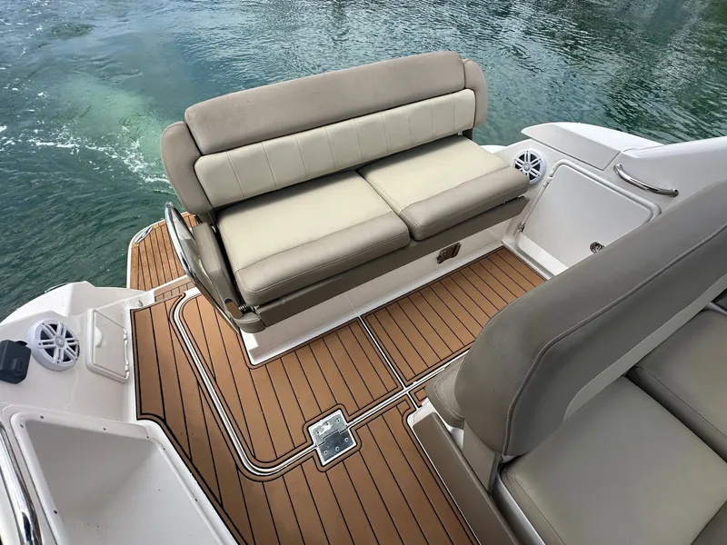 Slide: The Image of The image shows the cockpit of a 2014 Regal 30 Express with beige seating and teak flooring. - 10