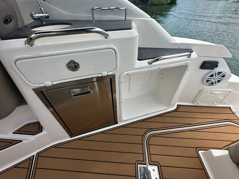 Slide: The Image of The 2014 Regal 30 Express features a stylish galley with stainless steel sink and storage. - 14