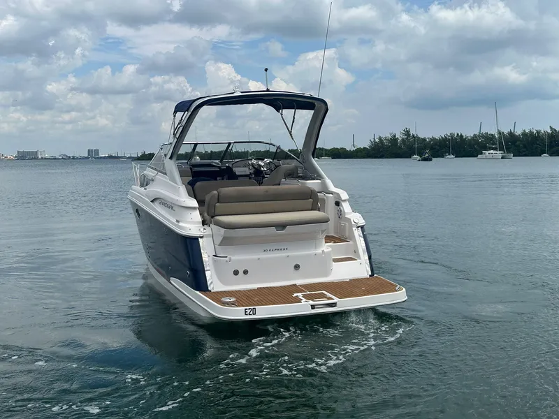 Slide: The Image of A 2014 Regal 30 Express boat on calm water with a cloudy sky. - 9