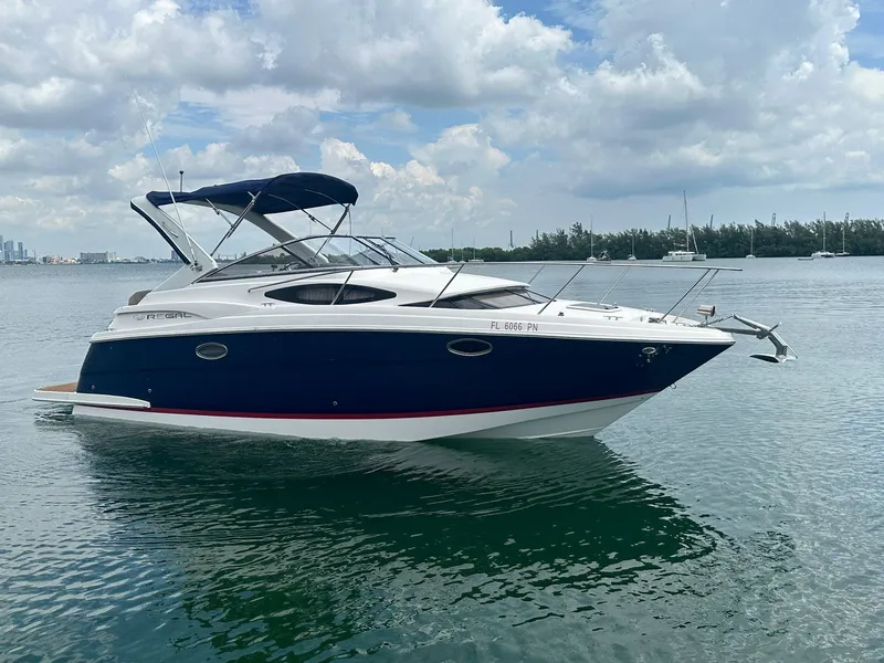 Slide: The Image of A 2014 Regal 30 Express boat on calm water with a cloudy sky. - 4