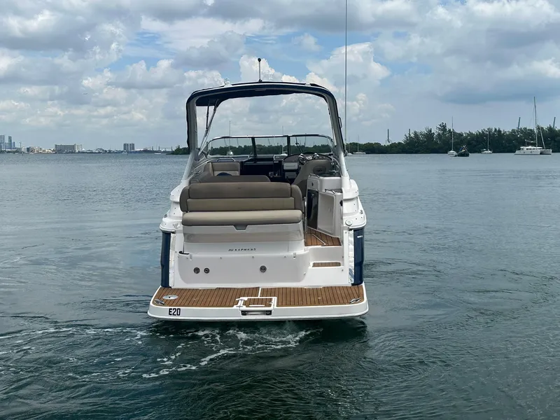 Slide: The Image of The image shows a 2014 Regal 30 Express on calm water. The sky is cloudy. - 8