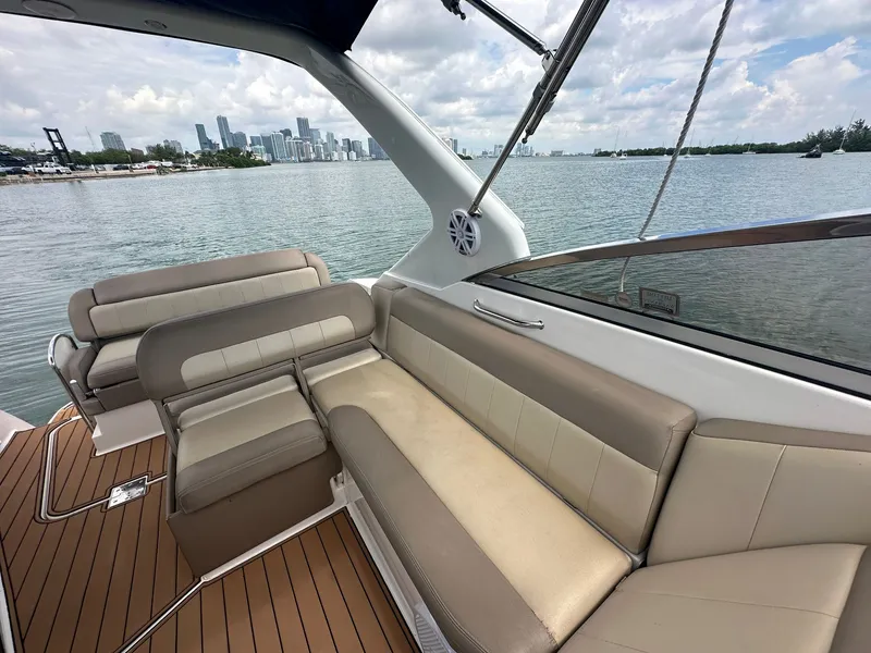 Slide: The Image of The image shows the cockpit of a 2014 Regal 30 Express with beige seating and wood flooring. - 16