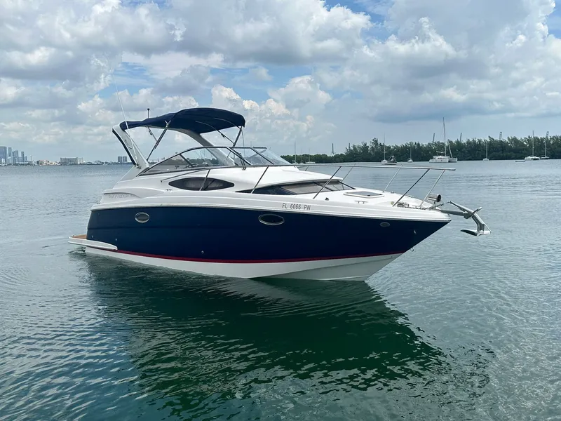Slide: The Image of A 2014 Regal 30 Express boat on calm water with a cloudy sky. - 5
