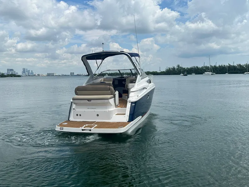 Slide: The Image of A 2014 Regal 30 Express boat cruising on calm water with a cloudy sky. - 7