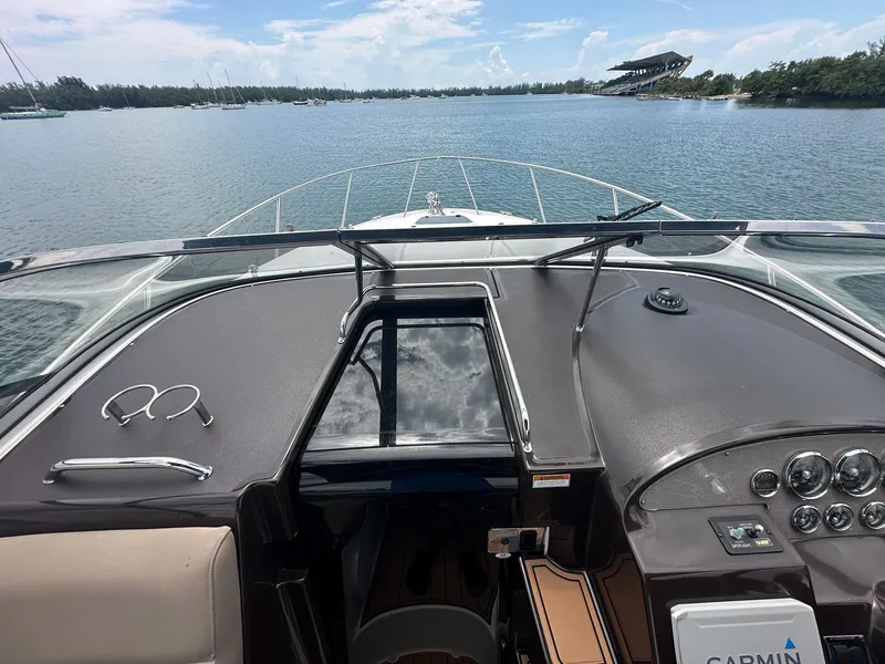 Slide: The Image of The image shows the cockpit of a 2014 Regal 30 Express with a view of the water. - 21