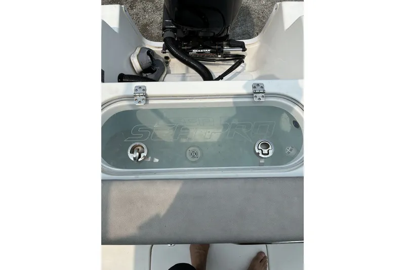 Slide: The Image of 2023 Sea Pro 242 Center Console boat livewell with clear lid and fittings. - 12