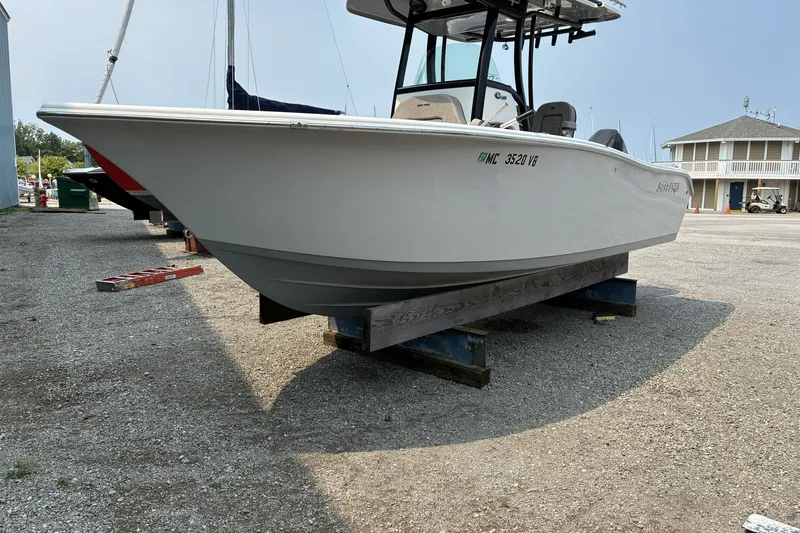 Slide: The Image of 2023 Sea Pro 242 Center Console boat on dry dock, side view. - 2
