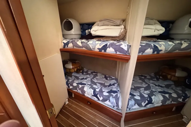 Slide: The Image of Bunk beds in 2005 Silverton 34 Convertible cabin with patterned bedding and wooden flooring. - 41