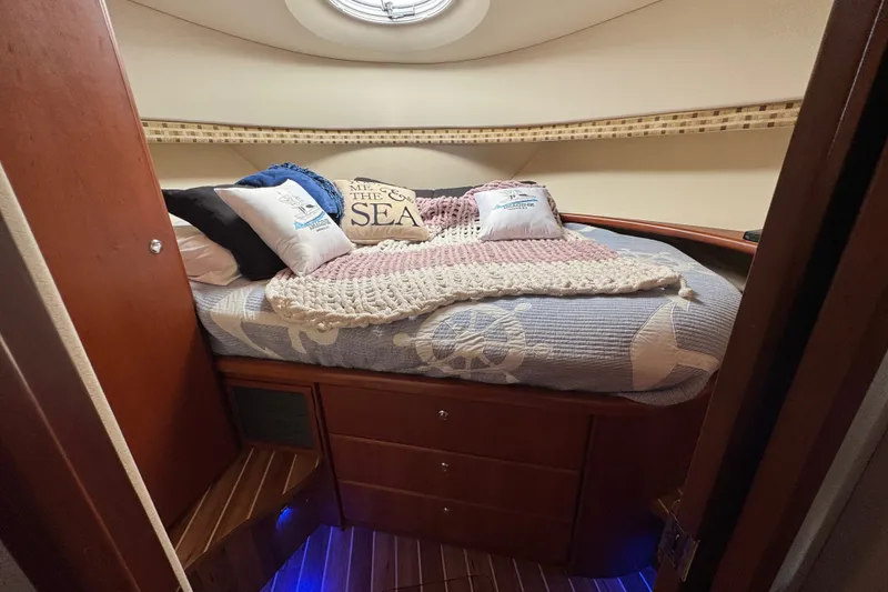 Slide: The Image of Cozy cabin interior of 2005 Silverton 34 Convertible yacht with nautical-themed bedding. - 40