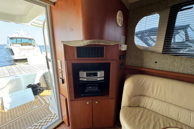 Slide: The Image of Interior of 2005 Silverton 34 Convertible yacht with entertainment system and dock view. - 37