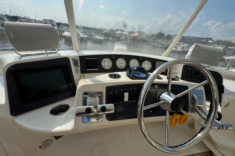 Slide: The Image of 2005 Silverton 34 Convertible boat helm with steering wheel and navigation instruments. - 29