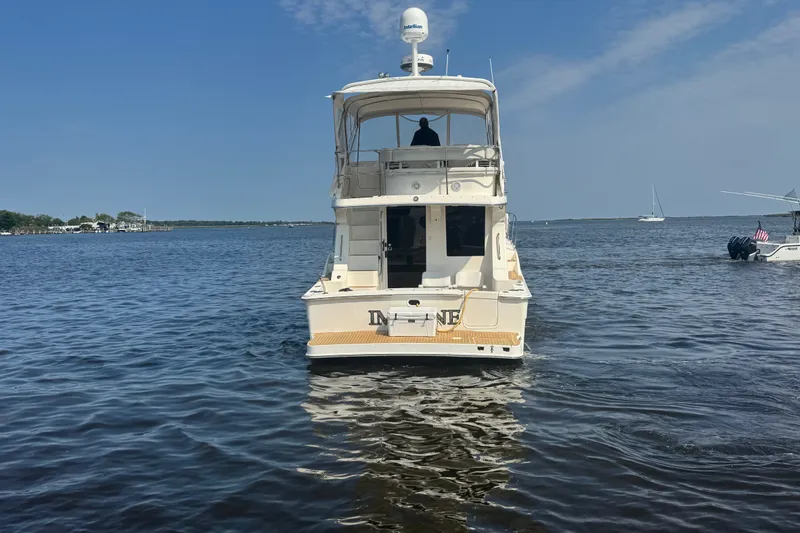Slide: The Image of 2005 Silverton 34 Convertible yacht on calm water under clear blue sky. - 16