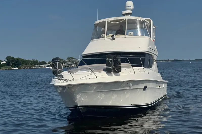 Slide: The Image of 2005 Silverton 34 Convertible yacht on calm water, clear sky background. - 13
