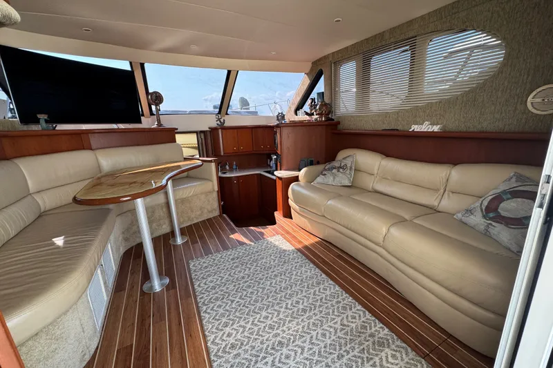 Slide: The Image of Luxurious interior of a 2005 Silverton 34 Convertible yacht with plush seating and elegant wood finishes. - 31