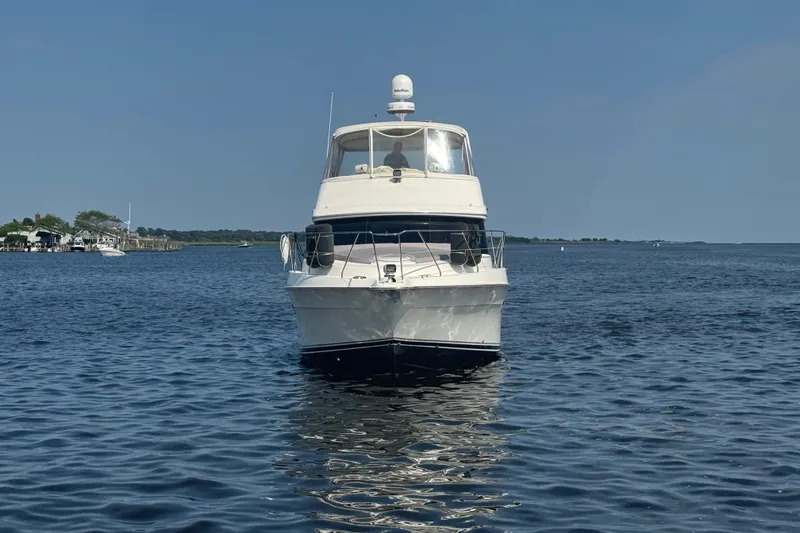 Slide: The Image of 2005 Silverton 34 Convertible yacht on calm water, clear sky background. - 9
